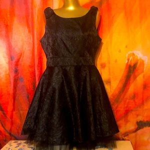 Black leather and lace feel textured dress. Very beautiful